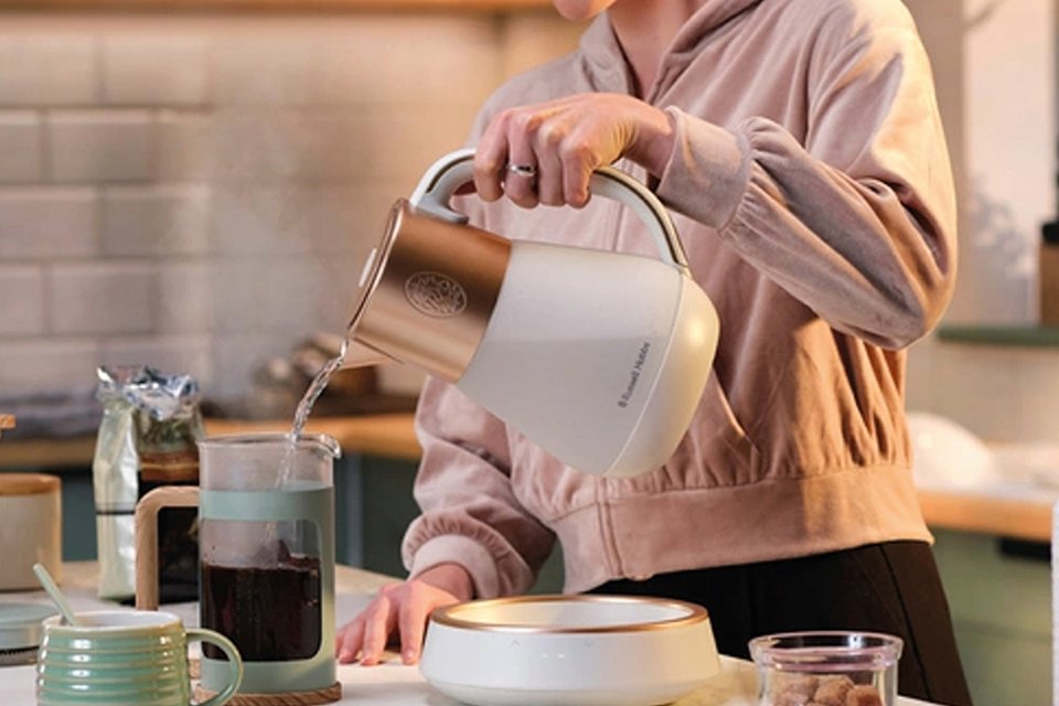 Quiet Mark certified Russell Hobbs Calm kettle pouring hot water into cafetière.